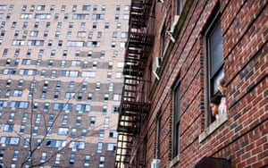 People look out their window at the apartment building on East 181st Street which was the scene of a fire in the Bronx borough of New York.